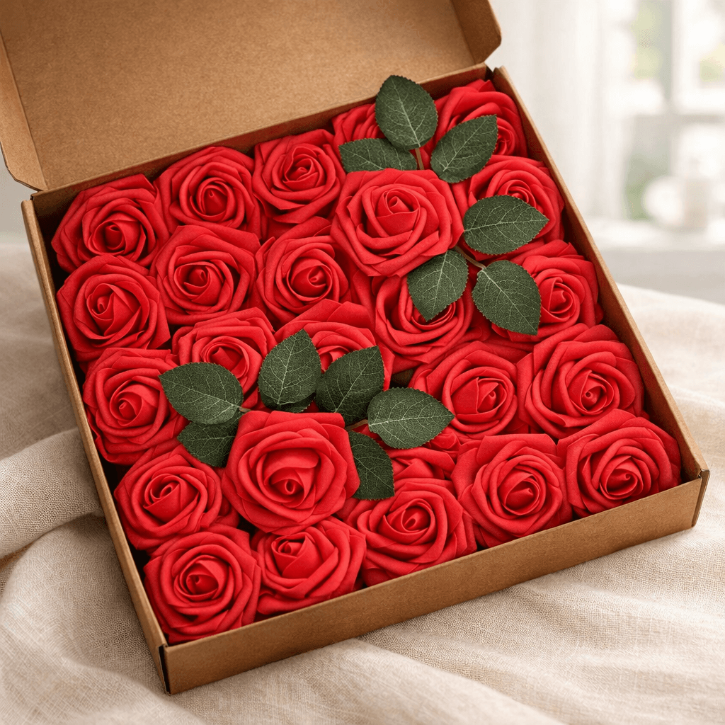 A box of red artificial roses with green leaves, ready to scatter around a bedroom