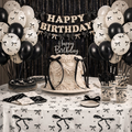 Black and white cake topper with bow tie details and elegant cupcakes for monochrome party.